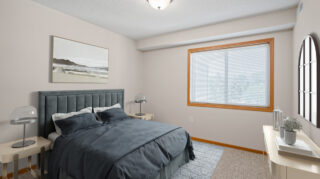 Private apartment bedroom with bed, nightstands, and window at Cornerstone Assisted Living in Plymouth MN.