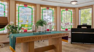 Chapel altar with candles and stained glass windows at Cornerstone Assisted Living in Plymouth MN.