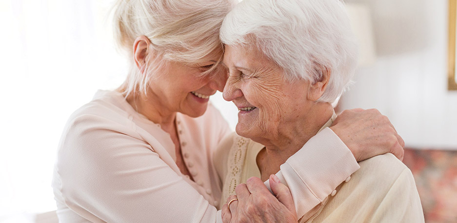 Resident shares a close, supportive moment with a caregiver at a community like Cornerstone Memory Care in Plymouth MN.