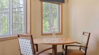 Small table with two chairs and window views at Cornerstone Assisted Living in Plymouth MN.
